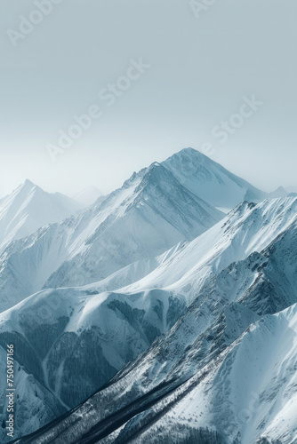 Tranquil winter scene unfolds with snow covered and towering mountains against a crisp blue sky. Minimalistic background for social media post or smartphone wallpaper