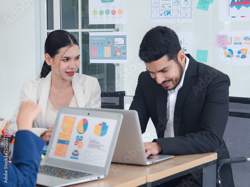 Portrait business team woman pretty girl cute and man handsome smart Asian two people meeting sitting on desk looking hand holding laptop ready for happy working online sale inside the home office