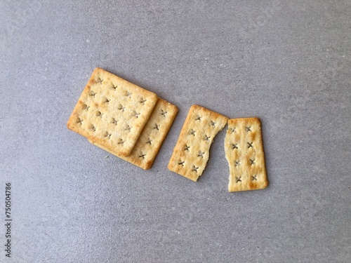 3 crackers, 1 crackers broken, plain background photo