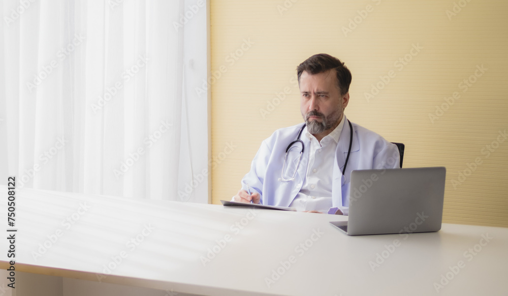 Portrait man doctor health care caucasian senior sitting one people sit working think analyzing on desk with computer documents and patient information inside hospital madical clinic office room Portrait man doctor health care caucasian senior sitting one people sit working think analyzing on desk with computer documents and patient information inside hospital madical clinic office room