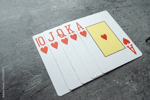 Hearts royal flush poker combination on grey background photo