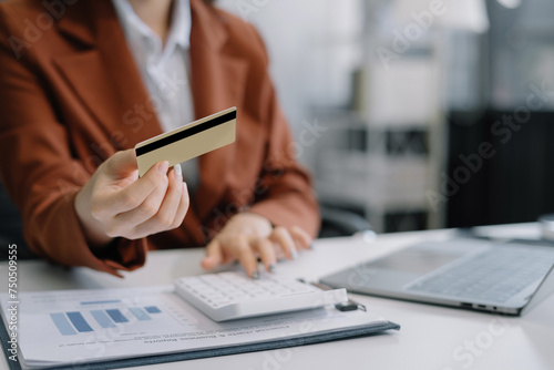 Businessman calculating monthly office expenses, taxes, bank account balance and credit card bills payment.