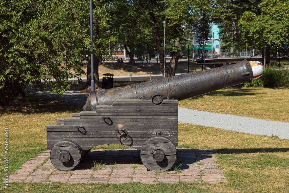 Old antique cast iron canon outdoors in park.