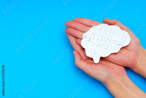 Brain Puzzle in Hands on Blue