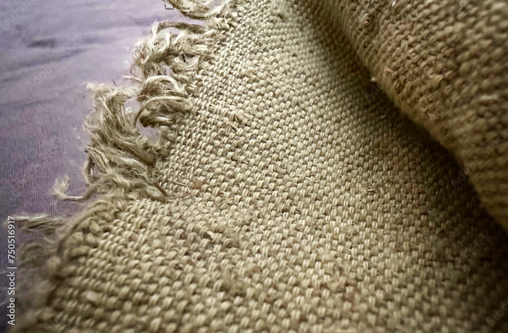 Burlap fabric with raw edge close up. Natural 100% hemp fabric, organic. Hessian Burlap fabric with raw edge close up. Natural 100% hemp fabric, organic. Hessian