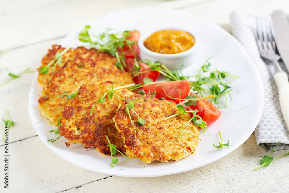 Potato fritters or pancakes served with sauce. European cuisine. Kosher eating. Vegan food. Potato fritters or pancakes served with sauce. European cuisine. Kosher eating. Vegan food.