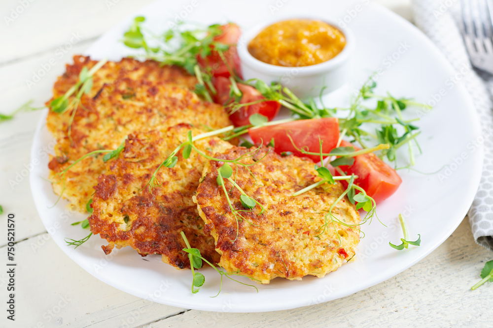 Potato fritters or pancakes served with sauce. European cuisine. Kosher eating. Vegan food. Potato fritters or pancakes served with sauce. European cuisine. Kosher eating. Vegan food.