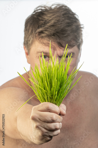 boy with a bunch of grass