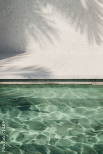 Tropical summer background with concrete wall, pool water and palm leaf shadow. Luxury hotel resort exterior scene mockup template. Outdoor vacation holiday house with neutral architecture aesthetic.
