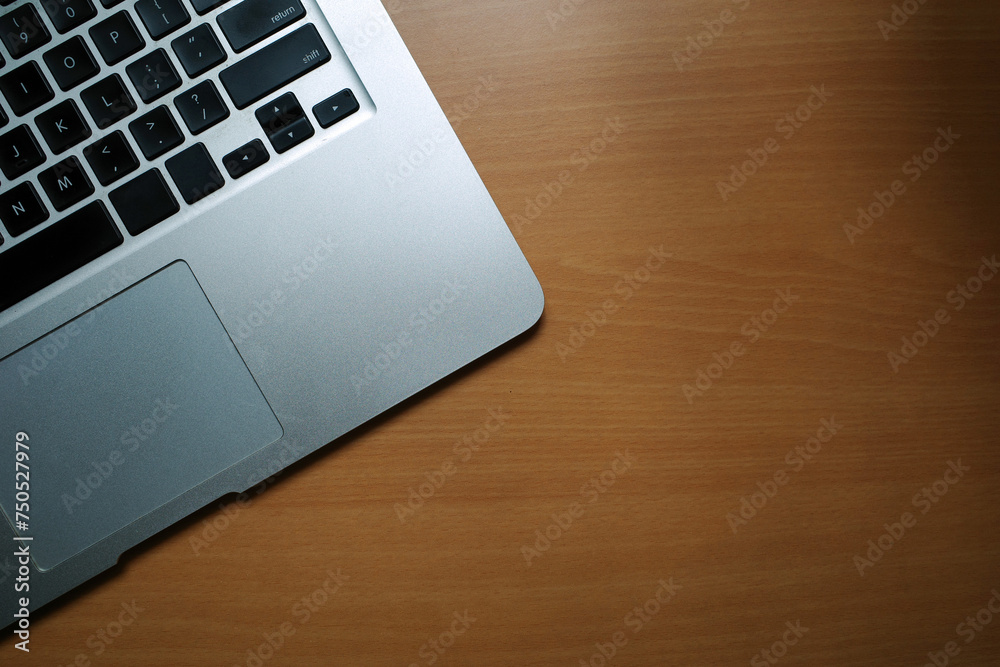 A business desk table with a laptop. Wood background with copy space. A business desk table with a laptop. Wood background with copy space.