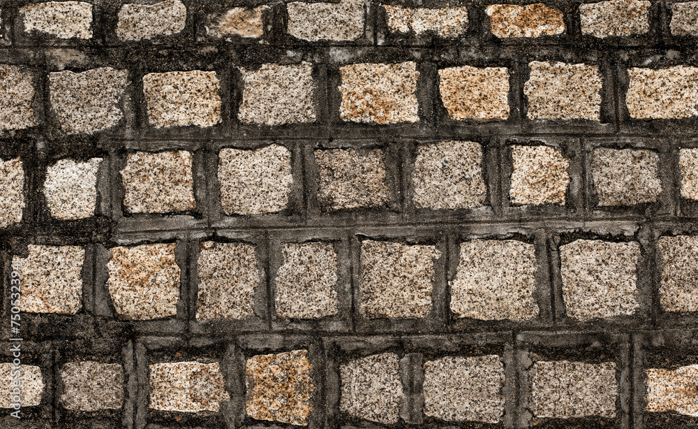 Stone wall textured background. Dark brown and beige bricks have textured and uneven shapes. Stone wall textured background. Dark brown and beige bricks have textured and uneven shapes.