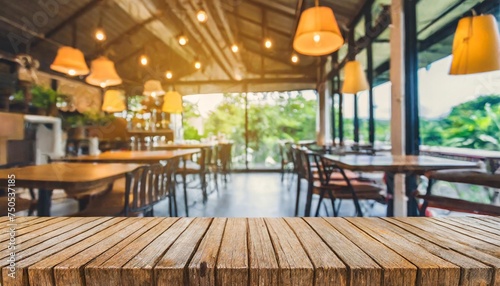 empty wooden table and coffee shop blur background with bokeh image