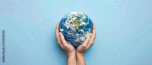 Arms hugging the Earth, demonstrating care for our planet, on a light blue background