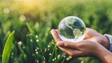 earth day or world environment day environmentally friendly concept save our planet restore and protect green nature sustainable lifestyle and climate literacy theme crystal glass globe in hands