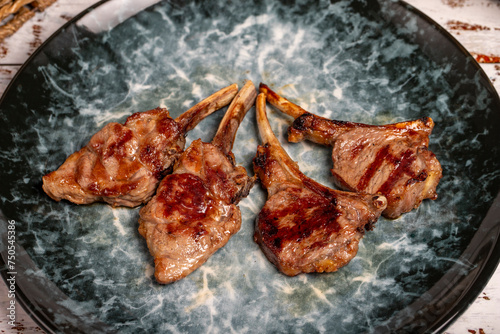 Freshly grilled lamb chops. Slices of cooked lamb chops on wood background. high quality photo. Close up