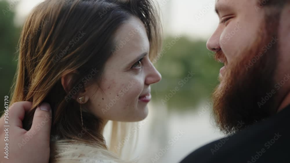 Closeup on love couple man and woman sitting embraced on nature and looking into eyes each other on romantic date. Happy male and female spending time together. Tenderness in relationship Closeup on love couple man and woman sitting embraced on nature and looking into eyes each other on romantic date. Happy male and female spending time together. Tenderness in relationship
