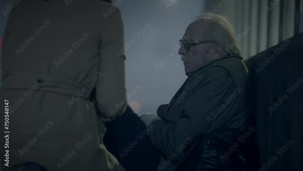 Kind Woman Helping Sad Elderly Homeless Man Outside In Cold Night Kind Woman Helping Sad Elderly Homeless Man Outside In Cold Night