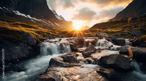 Waterfall illuminated by the golden light of sunrise in a mountainous setting photo