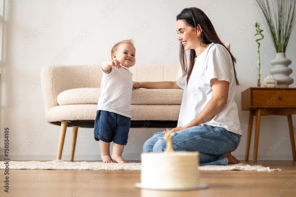 Woman Sitting on Floor Next to Baby