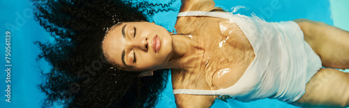 top view of relaxed african american woman swimming on her back in blue pool water  serenity banner