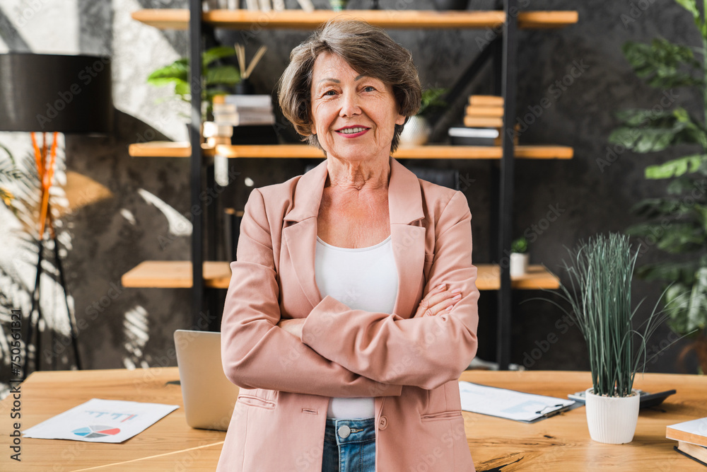 Portrait of successful caucasian senior businesswoman in formal attire with arms crossed in her private office. Hr manager ceo recruiter director looking at camera Portrait of successful caucasian senior businesswoman in formal attire with arms crossed in her private office. Hr manager ceo recruiter director looking at camera