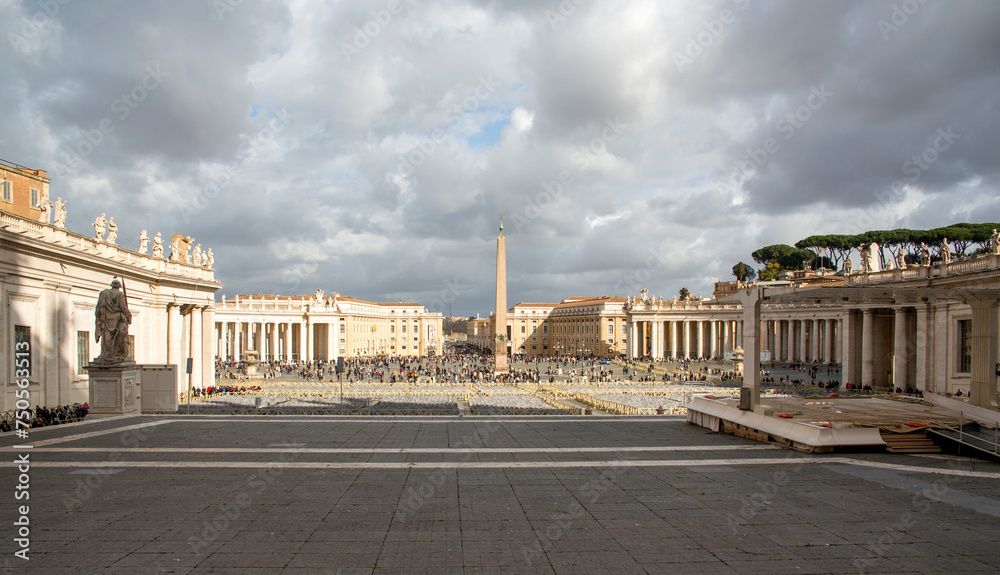 View of St. Peter's square located in the Vatican city. This state is an enclave within the city of Rome, Italy. The obelisk in the center is known as "The Witness". - obrazy, fototapety, plakaty 