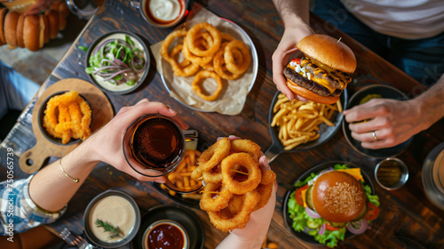 Friends enjoying a burger and onion rings © Cybonad