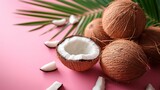 Coconuts on pink background, top view. Exotic fruit