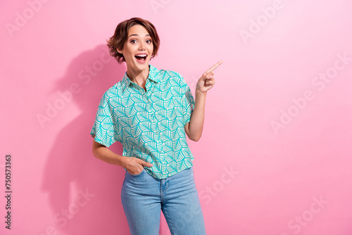 Portrait of shocked student lady promoter direct finger empty space wear casual shirt jeans pants isolated pink color background