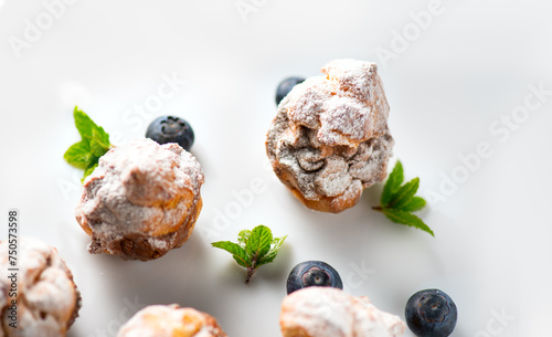 Profiterole or cream puff with filling,  powdered with sugar, with berries, isolated on white background, Fresh homemade Cream Puffs cake, French choux puff, ecler, dessert closeup. Pastries. Top view © Subbotina Anna