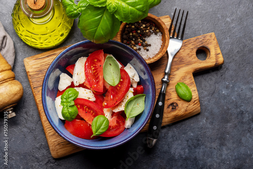 Caprese salad with ripe tomatoes, mozzarella cheese and garden basil