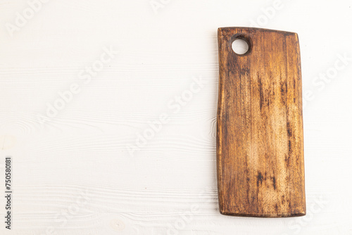 Empty rectangular wooden cutting board on white wooden. Top view, copy space