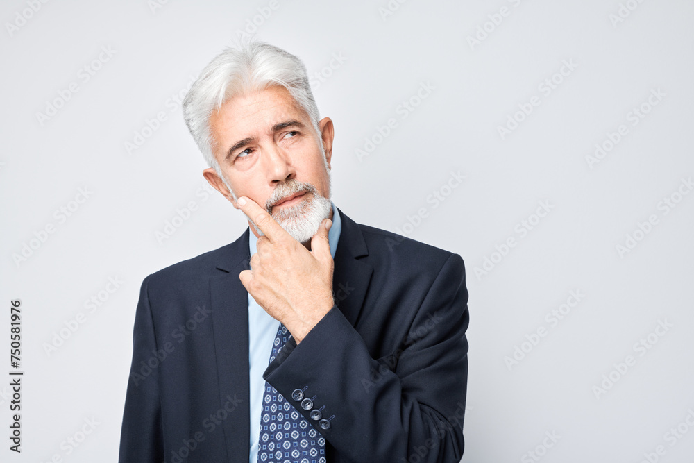 Thoughtful senior businessman hand on chin, contemplating isolated on a light background. Thoughtful senior businessman hand on chin, contemplating isolated on a light background.