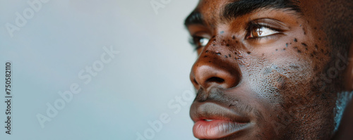 A powerful side-profile of a man's face, his eyes looking onward with purpose. The water droplets on his skin add a raw, textured depth to the image.