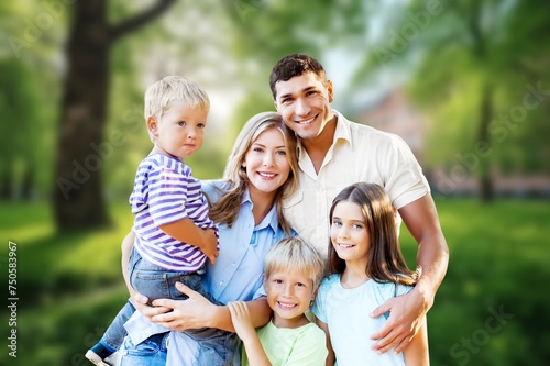 Young happy family with children playing in park