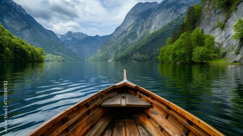 Enjoy in river under mountain, view from the bow of a small wooden boat to the calm lake and mountain landscape