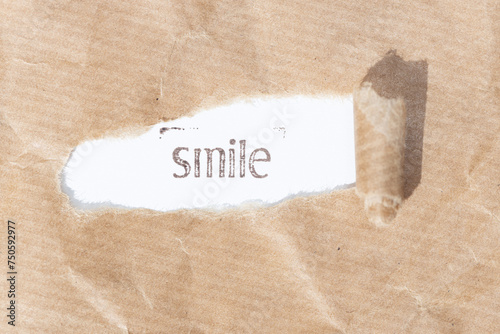 Smile message. Brown paper torn stripe with text on white paper background