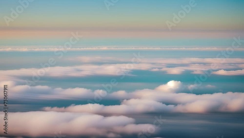 Majestic skies unfold, a canvas of blue expanse beneath, as clouds dance in harmony below. Meteorology concept. Video footage. Time-lapse. Summer sky background. 4K.
