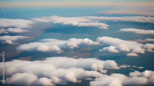 In the realm above, sunlight pierces through fluffy clouds, painting the sky in a breathtaking tapestry of blues.
