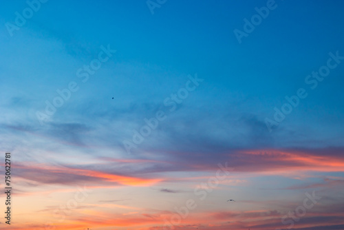 Beautiful partly cloudy sky at sunset or sunrise with pastel colors photo