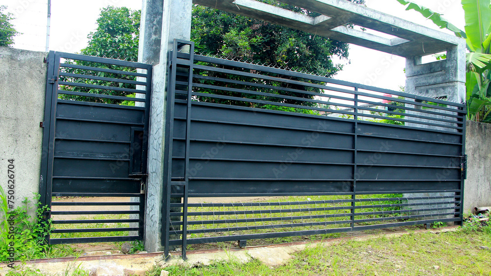 Gate fence, with barbed wire at the bottom and top Gate fence, with barbed wire at the bottom and top
