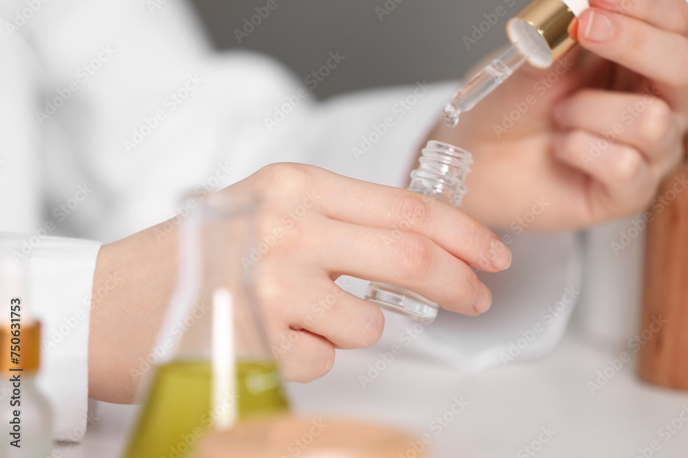 Dermatologist testing essential oil indoors, selective focus Dermatologist testing essential oil indoors, selective focus