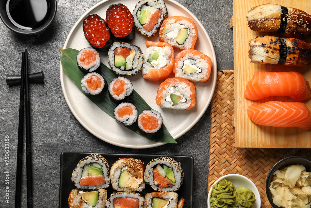Flat lay composition with delicious sushi rolls on dark grey table Flat lay composition with delicious sushi rolls on dark grey table
