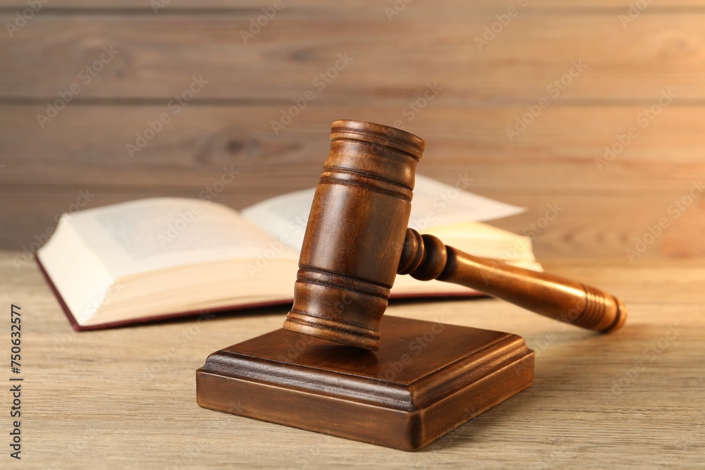 Wooden gavel and sound block on table, closeup