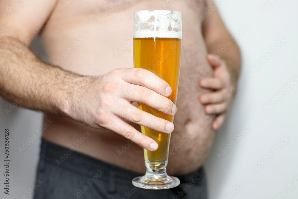 fat man with a mug of beer close-up. Beer belly, overweight. Man with mug of beer, close up. Alcoholism, unhealthy lifestyle fat man with a mug of beer close-up. Beer belly, overweight. Man with mug of beer, close up. Alcoholism, unhealthy lifestyle