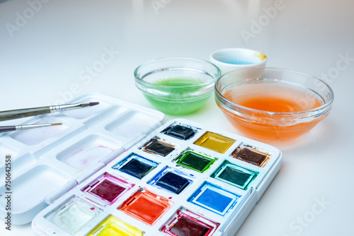 side view of watercolor kit on white background photo