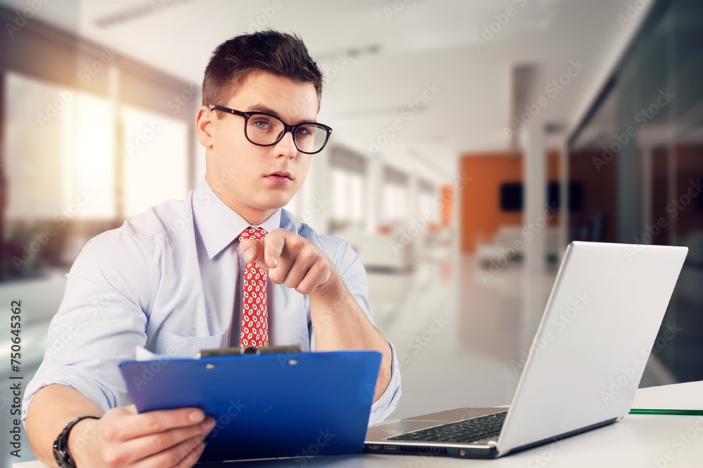 Young busy business man holding documents