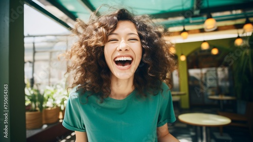 Playful lady in a green shirt her laughter echoing the lively spirit of a bright sunny day photo