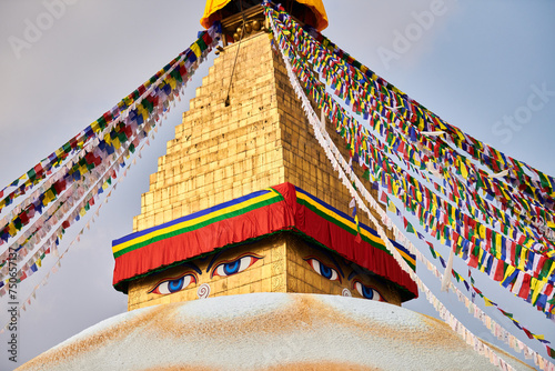 Boudhanath stupa in Kathmandu, Nepal decorated Buddha wisdom eyes and prayer flags, most popular tourist attractions in Kathmandu reflecting harmonious blend of spirituality and tourism photo