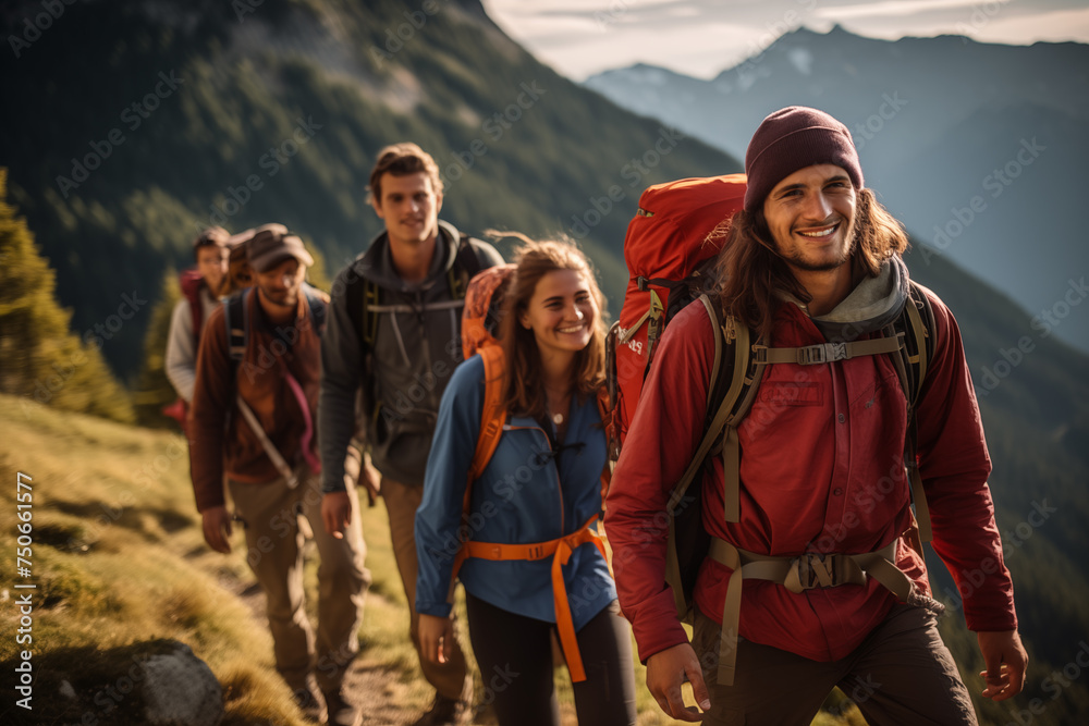 A group of tourists with backpacks descends a mountain trail during a hiking expedition.